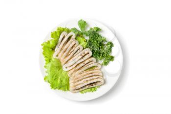 sliced squid and green vegetables dish isolated on white