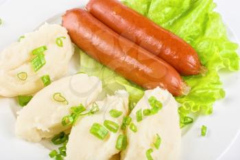Royalty Free Photo of Cutlets of Potato and Sausage on Lettuce