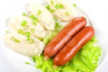 Royalty Free Photo of Potato Cutlets and Sausage on Lettuce