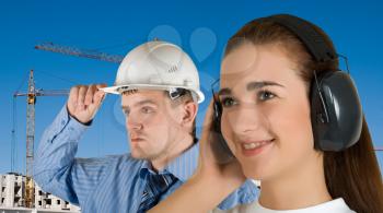 Royalty Free Photo of Workers Wearing Safety Earphones at a a Building Site