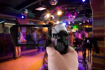 Royalty Free Photo of Someone Filming Dancers in a Club