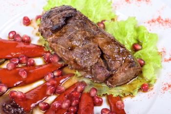 Royalty Free Photo of a Roasted Beef Steak With Pomegranates