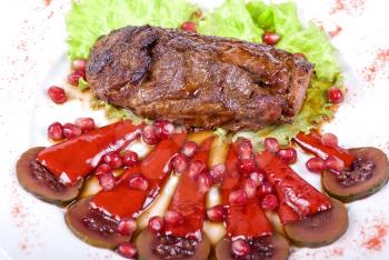 Royalty Free Photo of a Roasted Beef Steak With Pomegranates