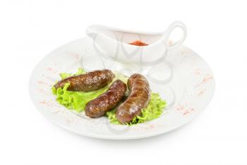 grilled venison sausage on a white with lettuce and sauce