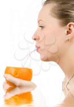 Royalty Free Photo of a Woman Drinking Out of an Orange