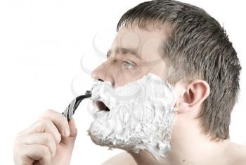 Royalty Free Photo of a Man Shaving His Face With a Razor