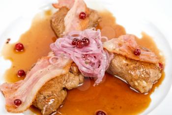 Royalty Free Photo of a Roast Pork Meat With Bacon, Onion and Cranberries