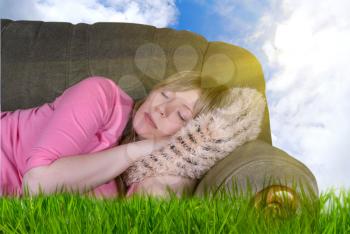 Royalty Free Photo of a Woman Sleeping on a Couch Outdoors