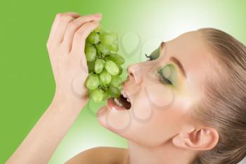 Royalty Free Photo of a Woman Eating Grapes