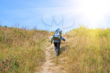 Royalty Free Photo of a Hiker With a Rucksack Up-Hill