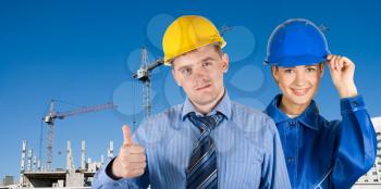 Royalty Free Photo of Workers in Front of a Building
