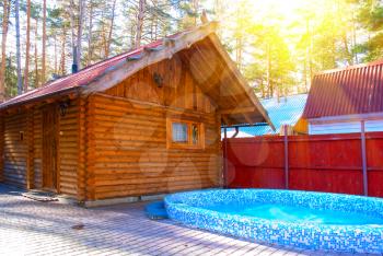 Royalty Free Photo of a Wooden House and Pool
