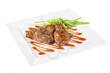 Roasted lamb meat tied with scallion closeup