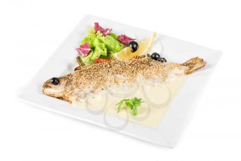 fish with lemon and greens on white background