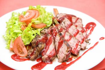 Royalty Free Photo of Roasted Beef With a Cranberry Sauce