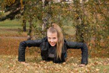 Royalty Free Photo of a Woman Doing Push-Ups in a Park