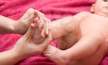 Royalty Free Photo of a Mother Massaging Her Baby's Feet