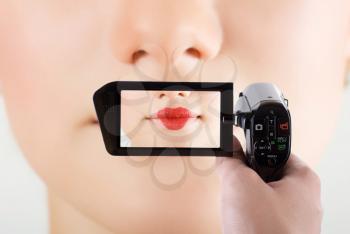 Royalty Free Photo of a Closeup of a Woman's Mouth Through a Camcorder