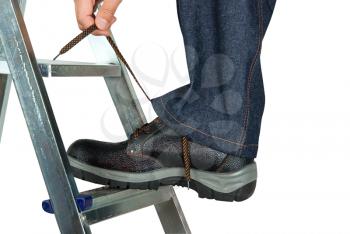 Royalty Free Photo of a Repairman Tying His Shoes on a Ladder