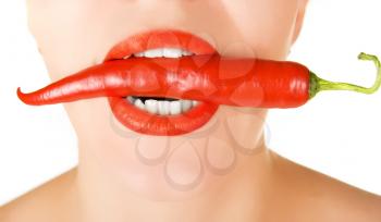 Royalty Free Photo of a Woman Biting a Pepper