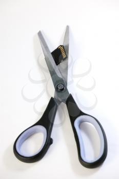 Royalty Free Photo of Scissors Cutting an SD Card 