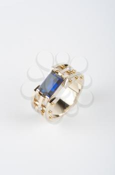 gold ring with big blue gem and smaller diamonds