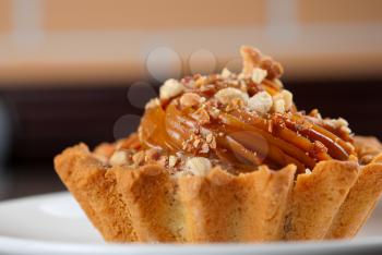 fresh baked cupcake with nuts on a wooden table