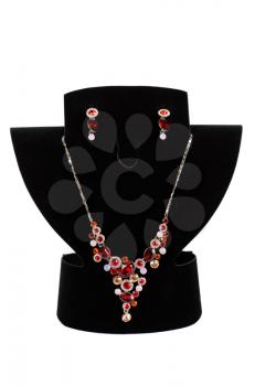 a necklace with pendants and earrings on a white background