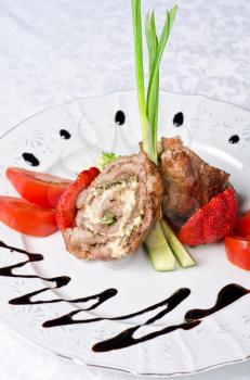 Pork rolls with cheese and vegetables: onion, cucumbers, tomatoes