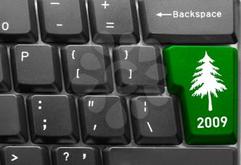 Close-up of computer keyboard with  green Christmas tree key