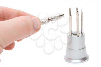 Hand with metallic screwdriver isolated on a white background