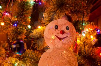 Beautiful Christmas fur-tree decorated with snowman toy