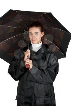 woman in rain coat with umbrella on a white