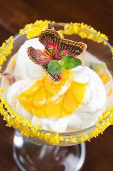 Ice cream dessert with kiwi and orange decorated with butterfly