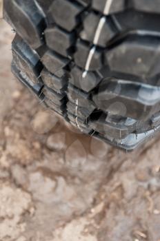 Close up of a car tire on a dirty road.