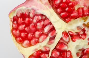 Half of pomegranate closeup on a white background