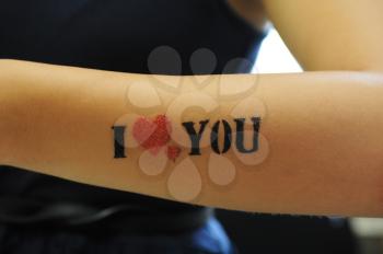closeup of tatoo I love you at woman hand