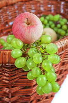 apples and grapes in a basket just harvest