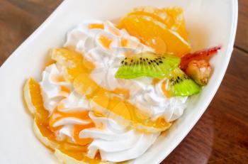 Ice cream dessert with kiwi, strawberry and orange