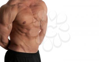 Muscular male torso of bodybuilder on black background