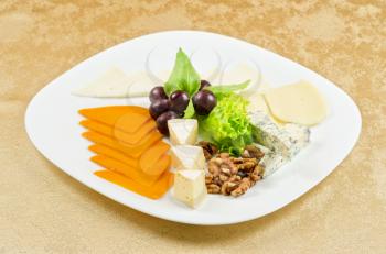 cheese with lettuce, grapes and nuts closeup