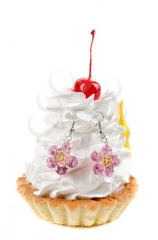 cupcake and bijouterie earrings on a white background