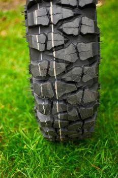 Tire at green grass background