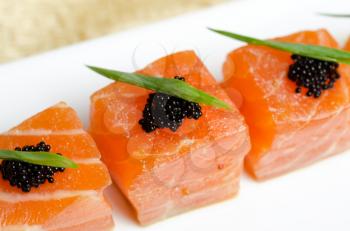 Salmon Slices with black tobiko caviar and greens