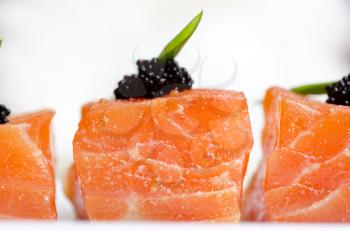 Salmon Slices with black tobiko caviar and greens