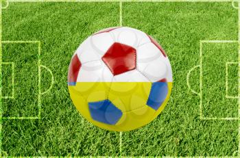 Soccer ball on grass field background