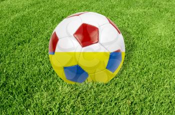Soccer ball on grass field background