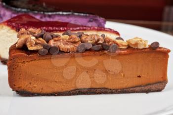 slice of cheesecake with chocolate and nuts