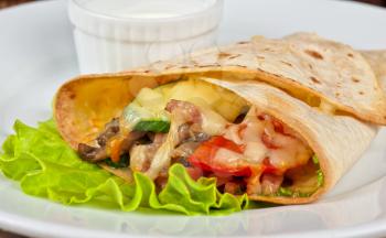 burrito with meat cheese and vegetables