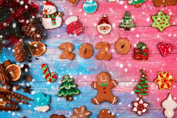 Gingerbreads for new 2020 year on wooden background, xmas theme